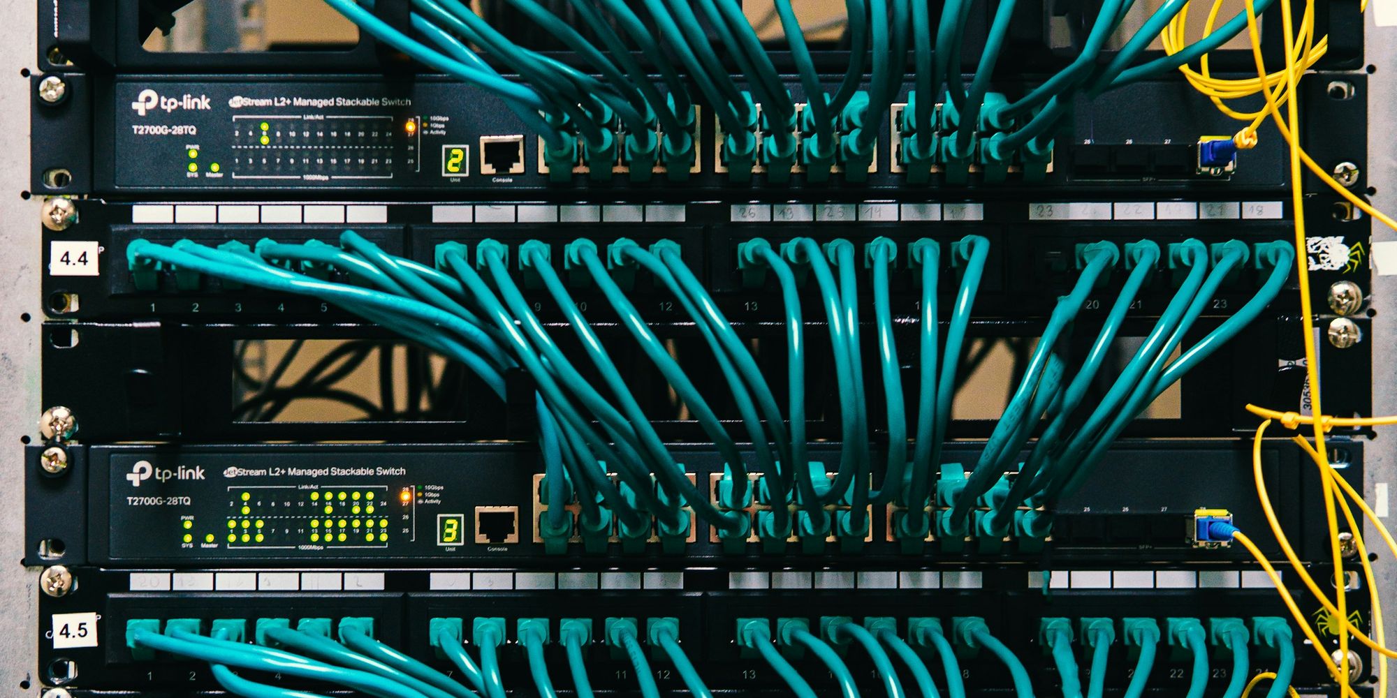A tidy server rack with colour-coded network cables routed into the switches